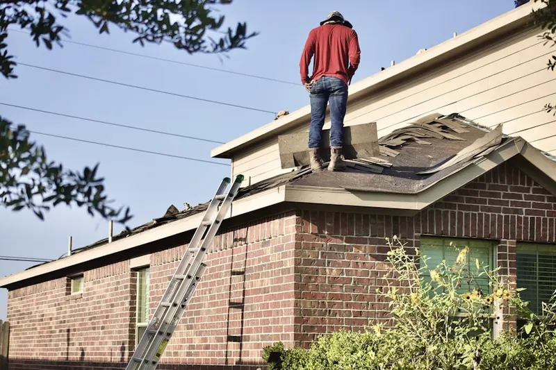 Professional roofer working on a residential roof in Fairview Estates
